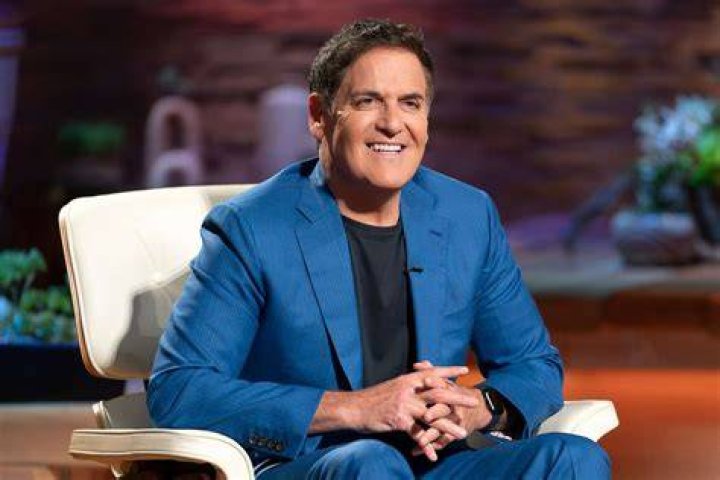 Mark Cuban is sitting on a chair on Shark Tank.
